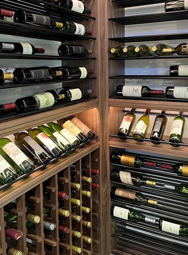 Wine bottles neatly arranged in a wooden rack, showcasing the Towers Series' signature styles and exclusive lines.